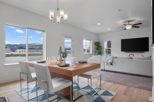 dining room featuring a mountain view, a chandelier, light wood-type flooring, recessed lighting, and ceiling fan