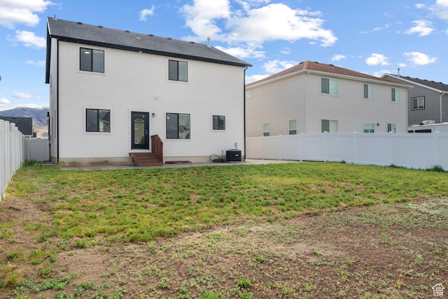 rear view of property with central AC unit, a patio area, entry steps, and stucco siding