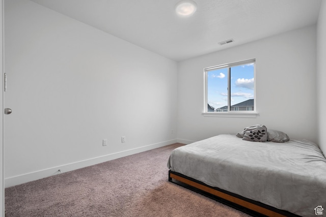 carpeted bedroom with baseboards