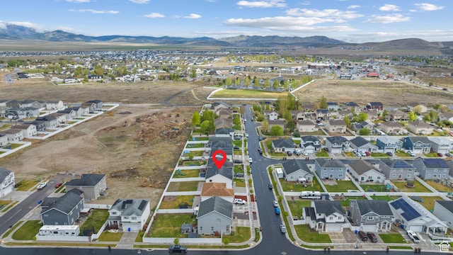 aerial overview of property's location with a mountain backdrop and nearby suburban area