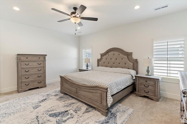 bedroom with light colored carpet, baseboards, recessed lighting, and ceiling fan