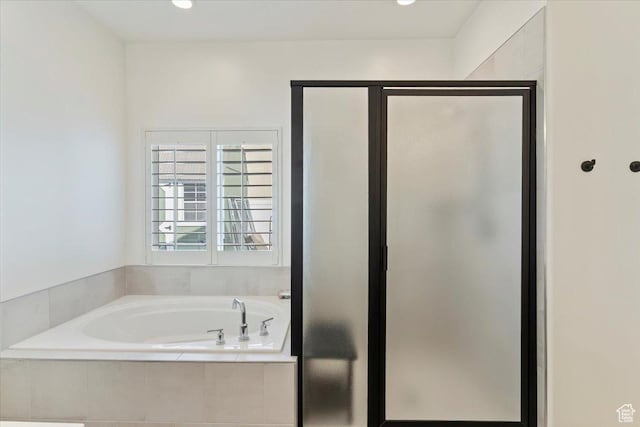 bathroom featuring a garden tub and a stall shower