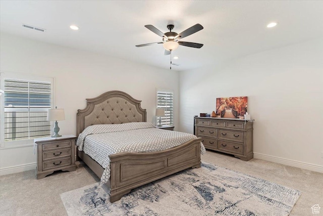 bedroom featuring light colored carpet, recessed lighting, baseboards, and a ceiling fan