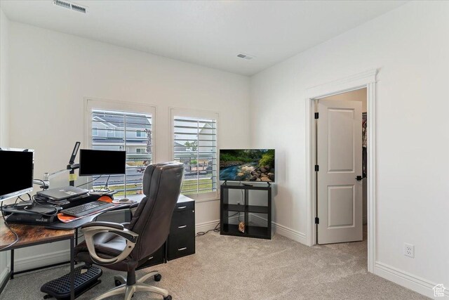 office space with light carpet and baseboards