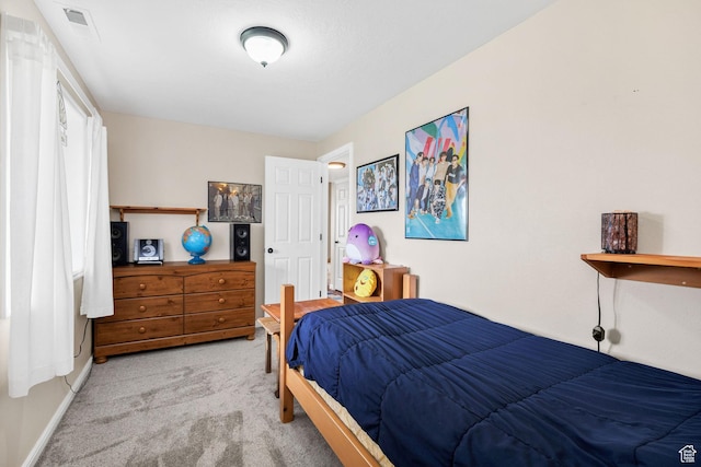 carpeted bedroom featuring baseboards