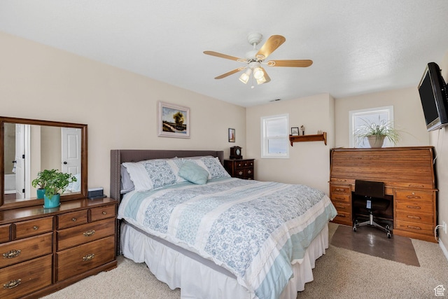 bedroom featuring an office area and a ceiling fan