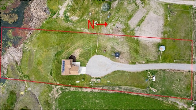 aerial view of property and surrounding area featuring property parcel outlined