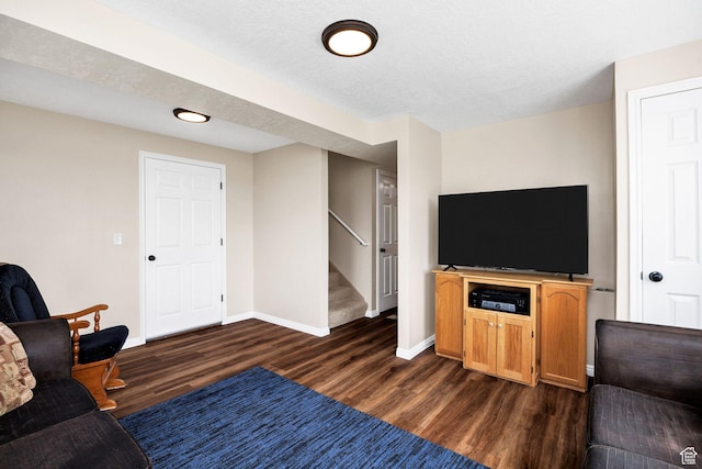 living area with dark wood-type flooring, stairway, and baseboards