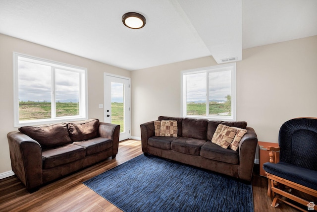 living area with wood finished floors and baseboards