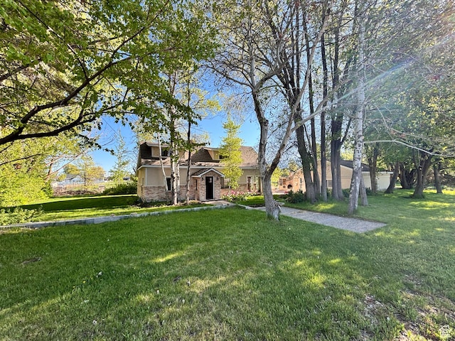 view of front of property featuring a front yard and stone siding