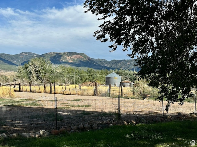 view of mountain backdrop with rural landscape