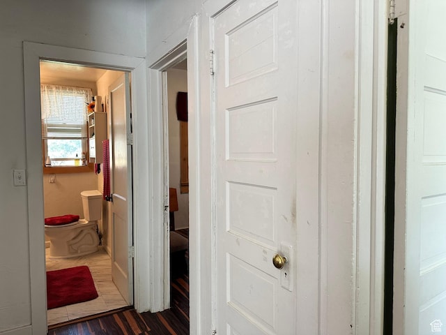 corridor with dark wood-style flooring