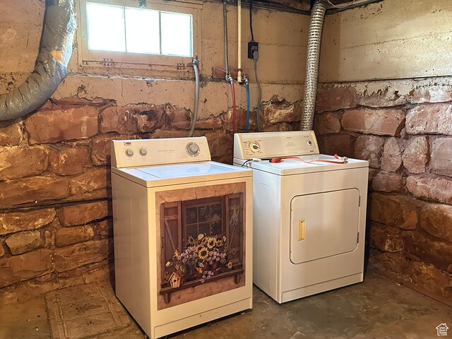clothes washing area featuring separate washer and dryer