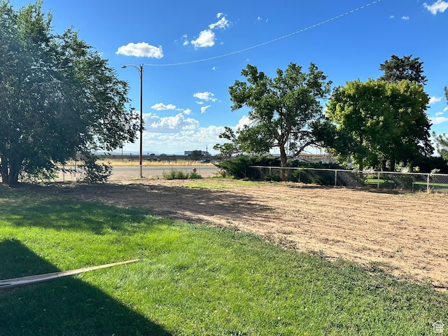 view of yard with fence and a view of rural / pastoral area