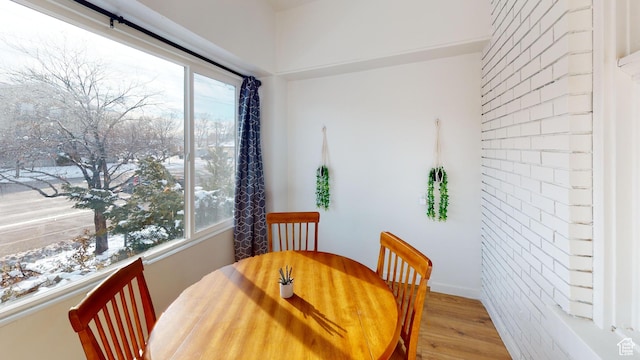 dining space with wood finished floors