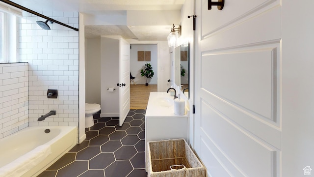 bathroom with toilet, tile patterned floors, and vanity