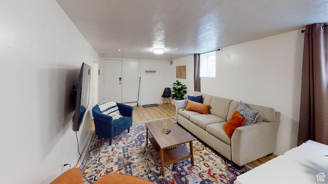 living room with light wood finished floors and a textured ceiling