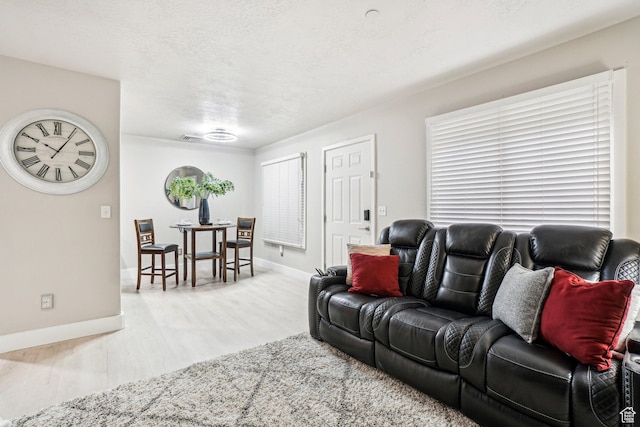 living room with wood finished floors and baseboards