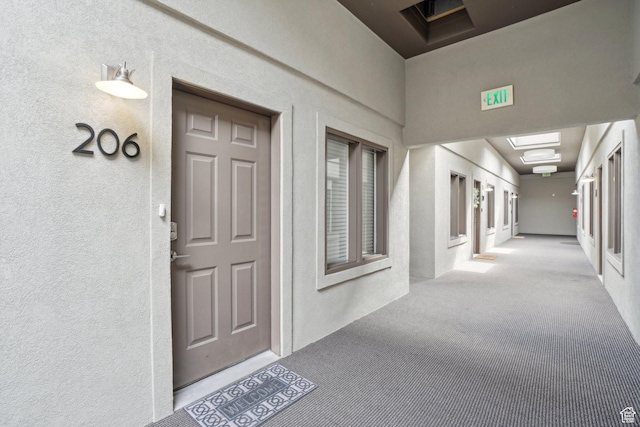 property entrance with stucco siding