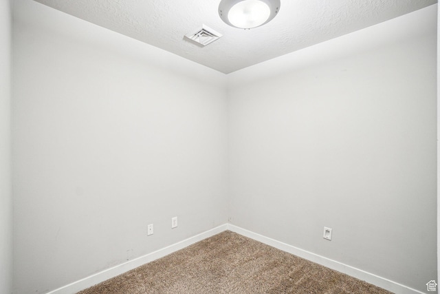 carpeted empty room with baseboards