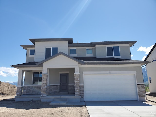 1186 N 1525 E Unit Arsf99, Payson, UT 84651 - view of front of property with stone siding, an attached garage, driveway, a porch, and stucco siding