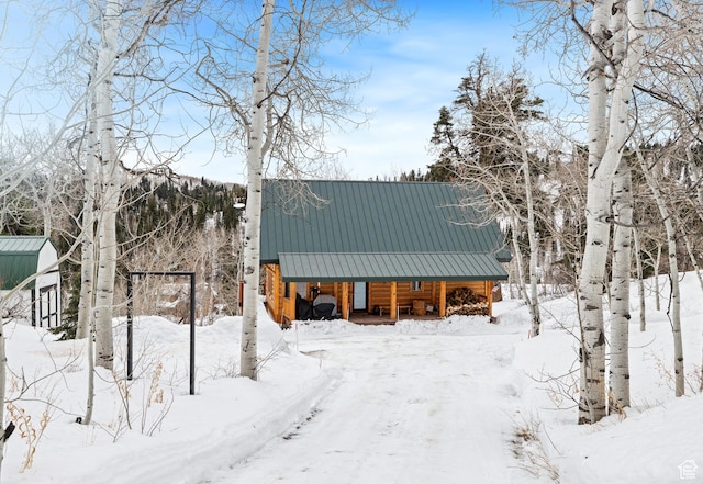snow covered structure featuring a porch