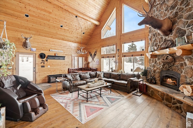living area with high vaulted ceiling, a fireplace, hardwood / wood-style floors, and beam ceiling
