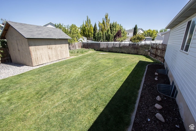 view of yard with an outdoor structure and a storage shed
