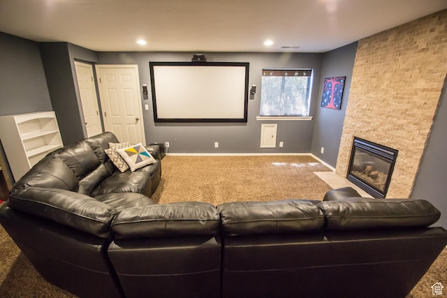 carpeted home theater featuring baseboards, a fireplace with flush hearth, and recessed lighting