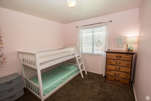bedroom featuring carpet and baseboards