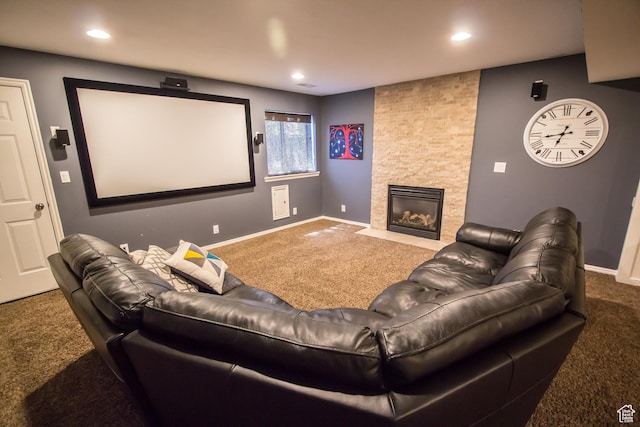 cinema room with carpet floors, baseboards, a stone fireplace, and recessed lighting
