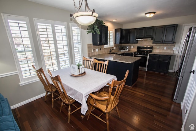 dining space featuring dark wood-type flooring, baseboards, and recessed lighting