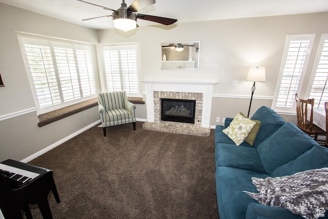 living area with a ceiling fan, carpet, a fireplace, and baseboards