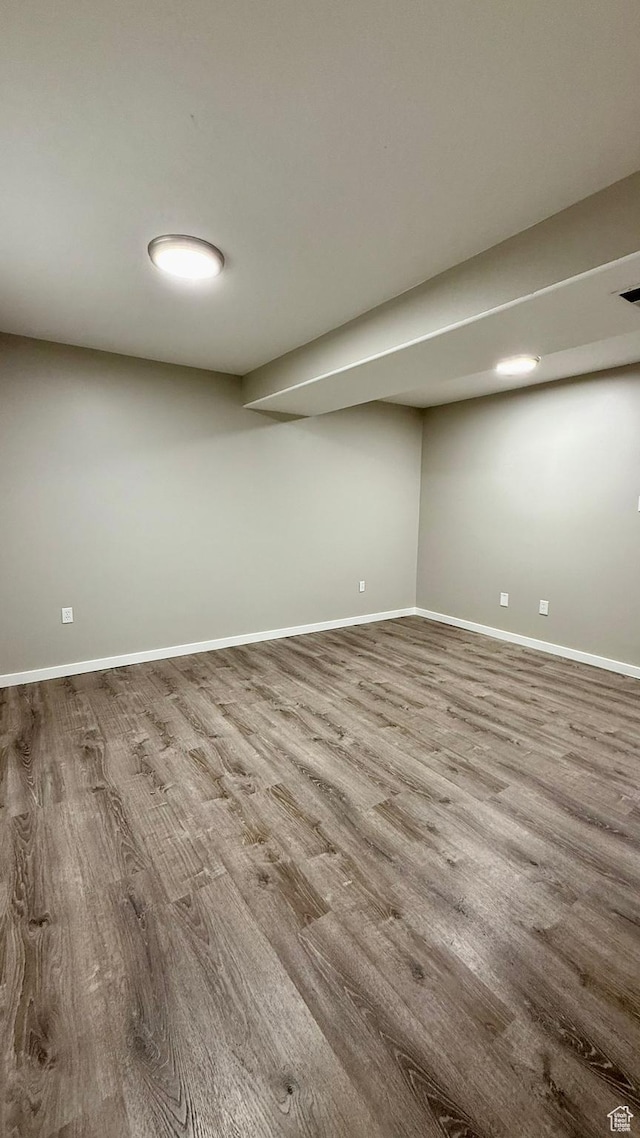 finished basement featuring wood finished floors and baseboards