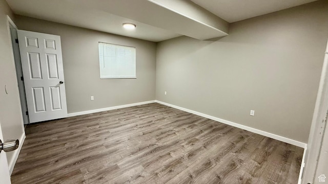 below grade area with wood finished floors and baseboards