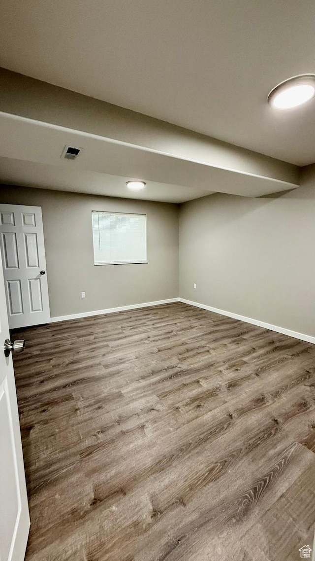 finished basement featuring wood finished floors and baseboards