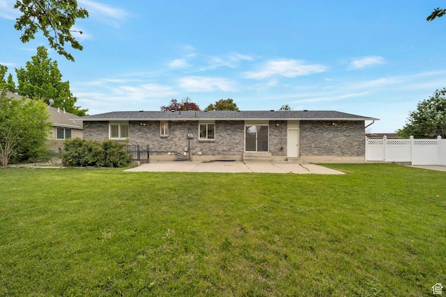 back of house with a patio area and brick siding