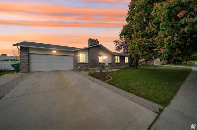 665 E Howard Dr, Sandy, UT 84070 - view of front of house with an attached garage, driveway, a yard, a chimney, and brick siding
