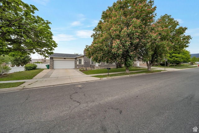 obstructed view of property featuring driveway and a garage