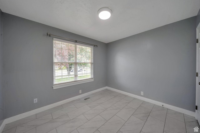 unfurnished room featuring baseboards