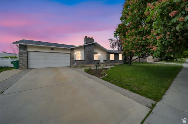 ranch-style house with a chimney, driveway, and an attached garage