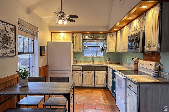 kitchen with white appliances, a sink, lofted ceiling, and ceiling fan