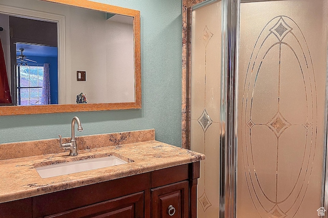 bathroom featuring vanity and a textured wall
