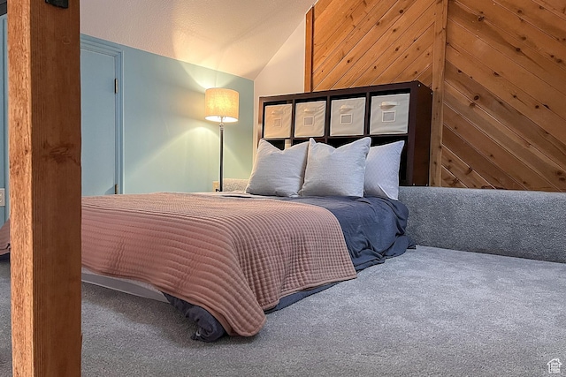 bedroom featuring carpet floors and vaulted ceiling