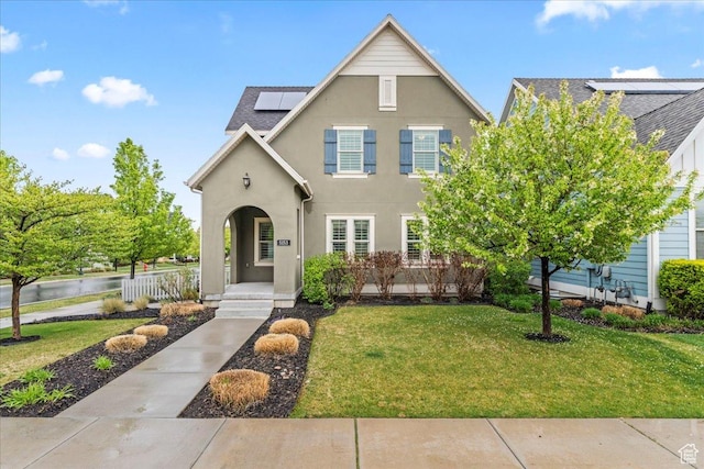 5153 W Bowstring Way S, Jordan, UT 84009 - view of front of house with solar panels, a front yard, stucco siding, and a porch