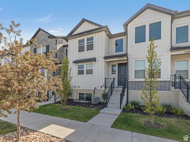 multi unit property with board and batten siding and a front yard