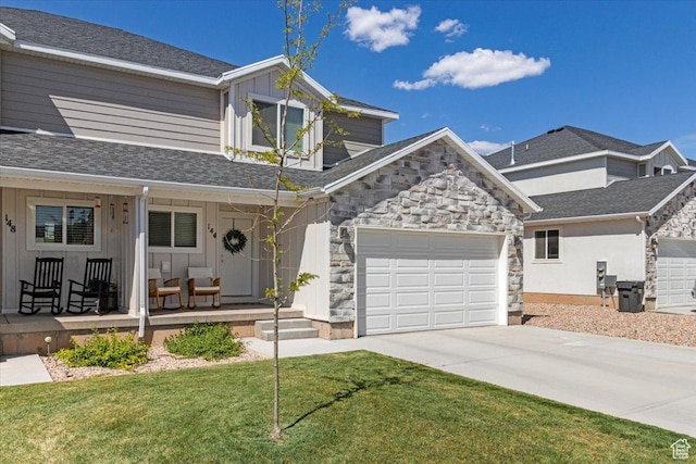 view of front of house featuring a porch, board and batten siding, concrete driveway, and stone siding