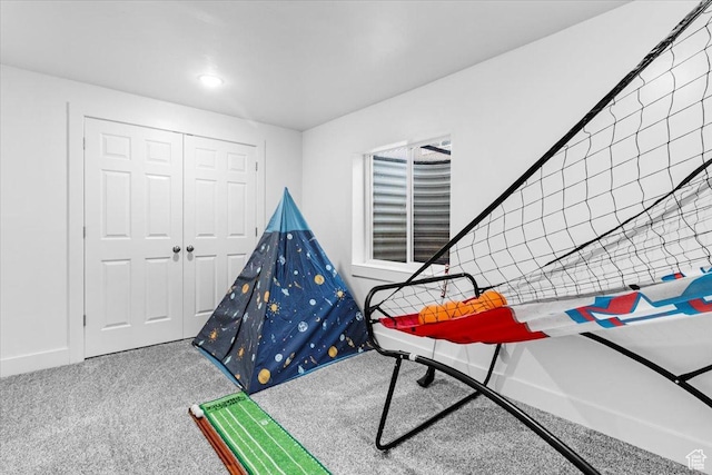 game room with carpet and baseboards