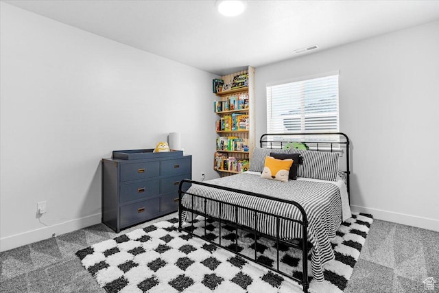 bedroom with baseboards and light colored carpet