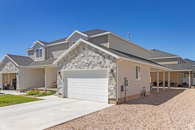 view of front of home featuring stone siding, an attached garage, and concrete driveway